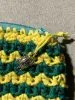 Crocheted change purse different. Colours striped